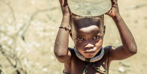 a child carries water in kunene namibia