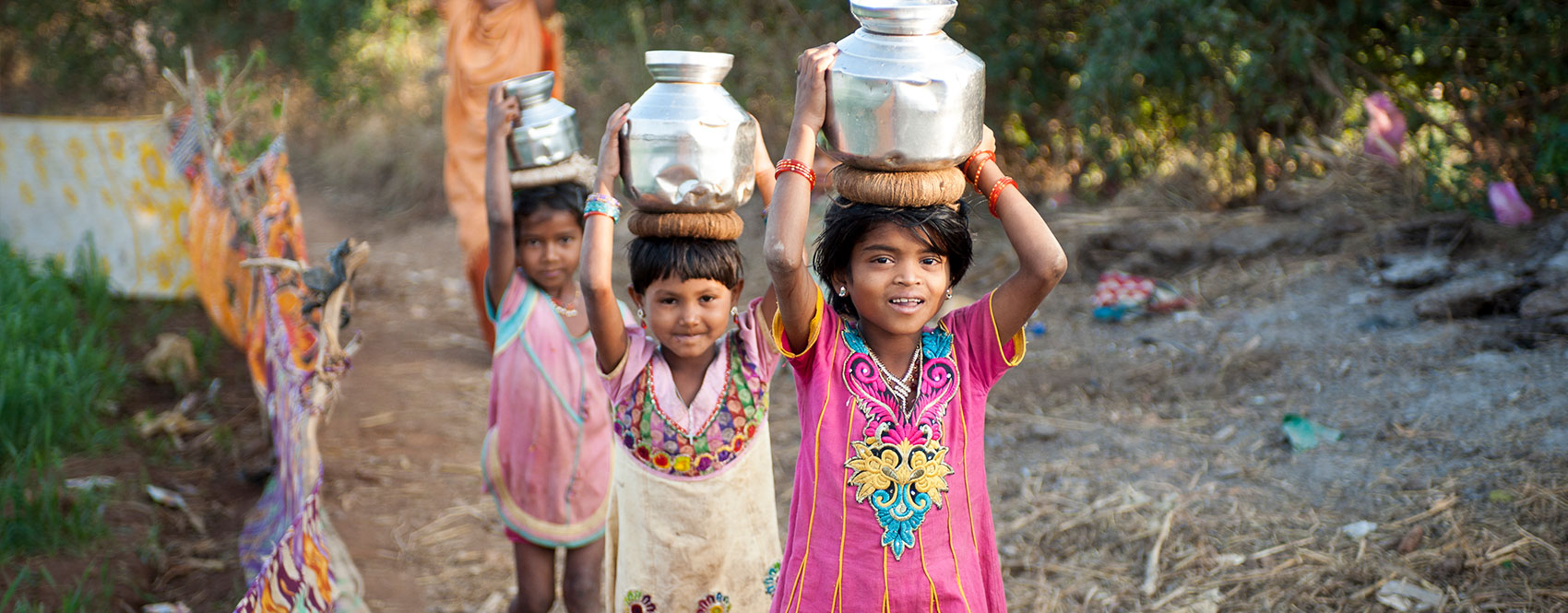 Asian girls carrying water for miles in a global clean water crisis