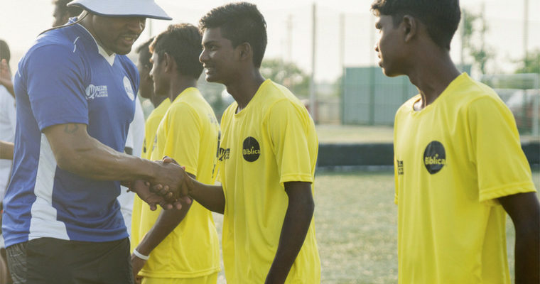Former NFL star Rashied Davis with participants in a soccer event in India who received a copy of Biblica’s Game of Life book, featuring Scripture and testimonies of leading Indian soccer players.