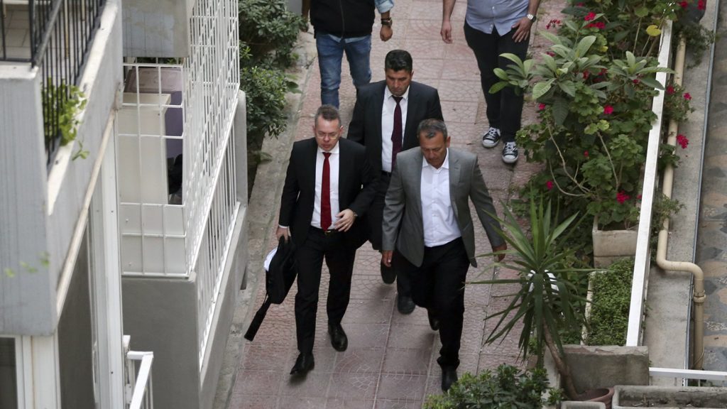 Pastor Andrew Brunson, front left, arrives at home after his release following his trial in Izmir, Turkey, on Oct. 12, 2018. A Turkish court on Friday convicted the American Pastor of terror charges but released him from house arrest and allowed him to leave Turkey, in a move that is likely to ease tensions between Turkey and the United States. (AP Photo/Emre Tazegul)