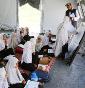 Girls study in a UNICEF-supported ‘tent school' in Afghanistan. Many of their families have been displaced by conflict. 