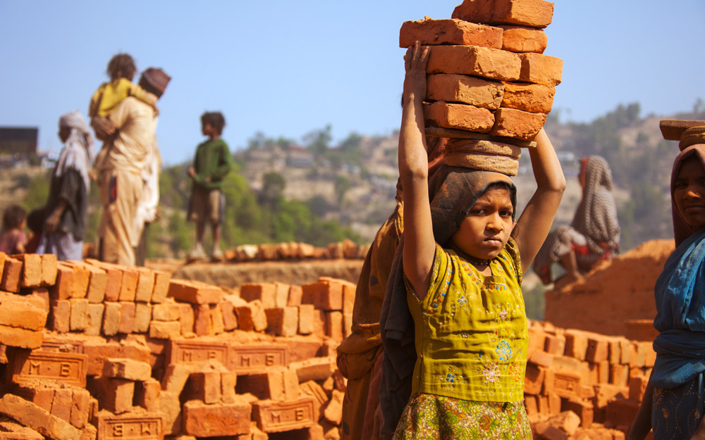 Children just like this young girl suffer verbal and physical abuse while working up to 16 hours a day at brick factory.