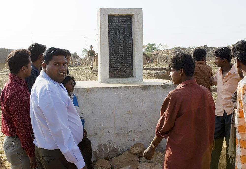 This plaque was erected in memory of 18 village children who died from starvation.