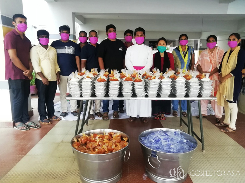 Gospel for Asia (GFA World and affiliates like Gospel for Asia Canada) founded by Dr. K.P. Yohannan: Pastor Vadin and his congregation prepare to distribute the packed food to travelers.