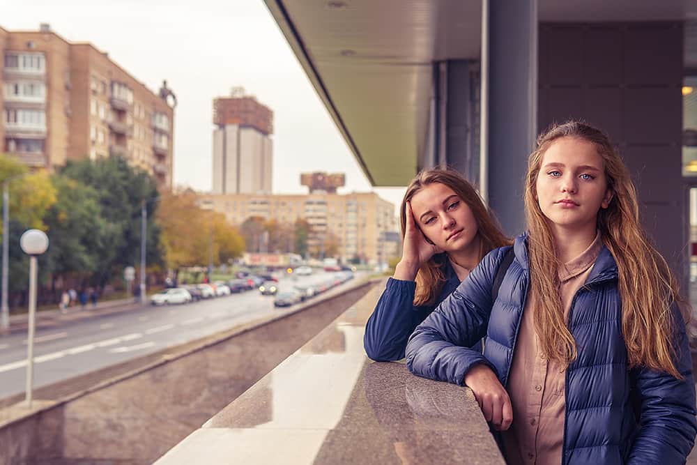 Two girls posing on a school balcony