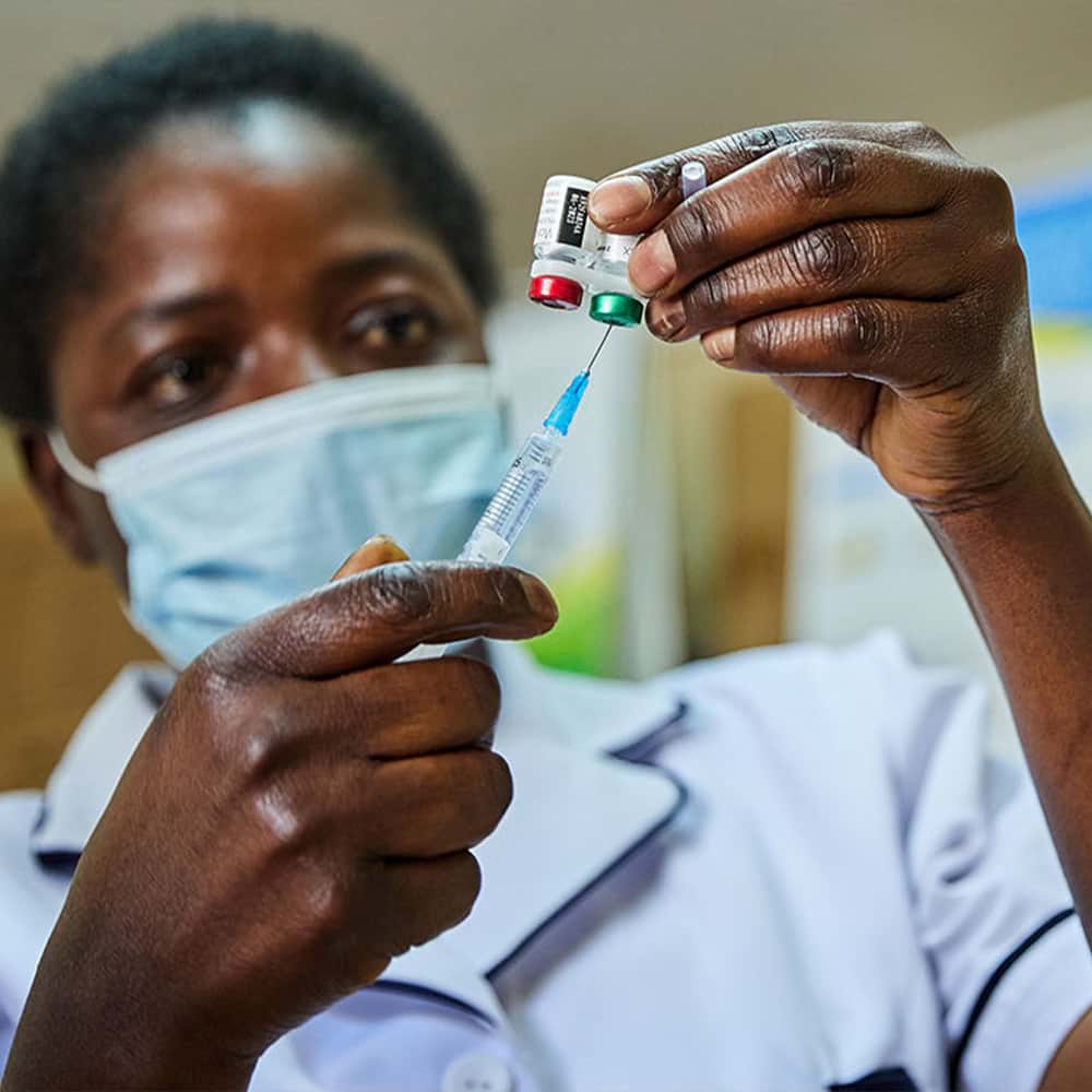 Nurse Janet Wanyama prepares to vaccinate a child against malaria